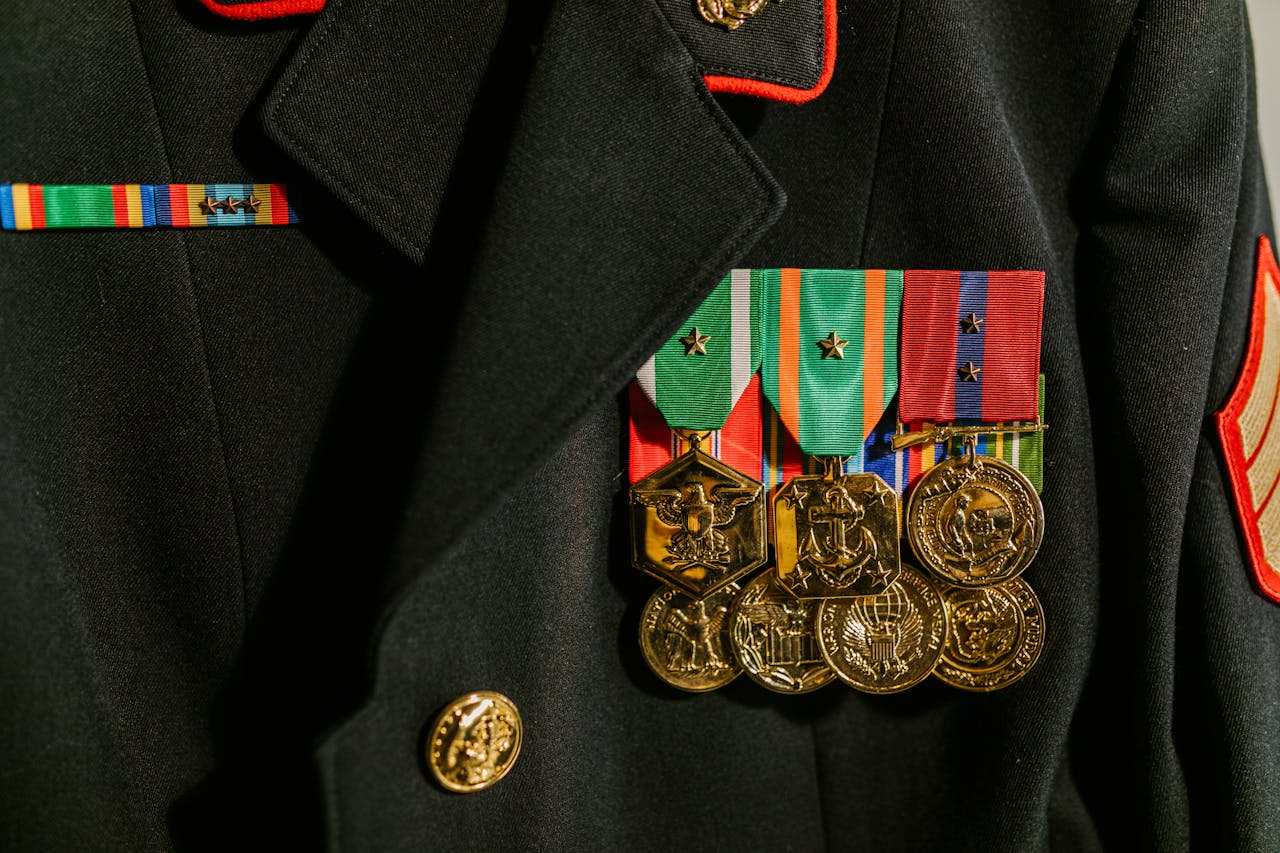 Close-up of a military uniform adorned with various medals of recognition and honor.